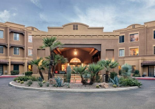 Fairwinds - Desert Point covered entrance and driveway with many palm trees