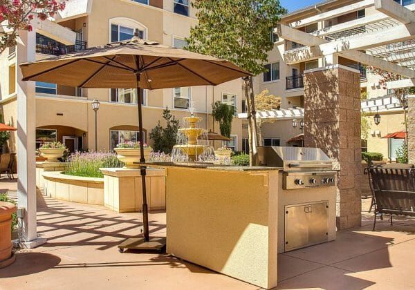 Outdoor barbeque and resident courtyard at Heritage Estates Senior Apartments