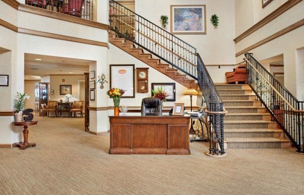 Reception desk and grand staircase in the lobby of Sunrise of Scottsdale