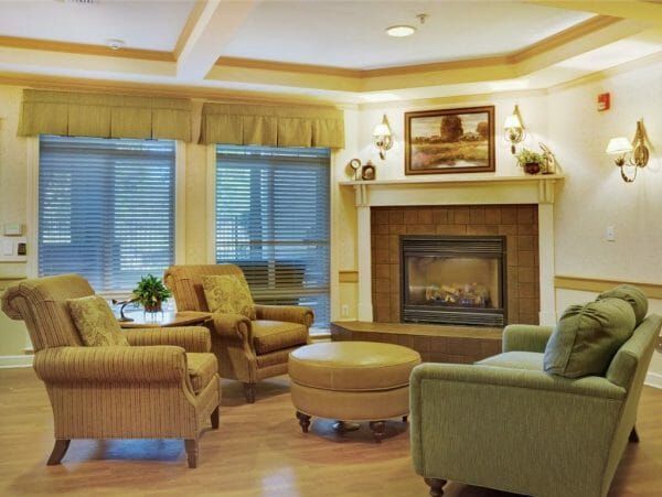 Community living room with large fireplace in Sunrise of Fair Oaks