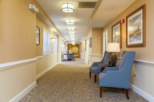 Resident seating in a Charter Senior Living of Williamsburg hallway