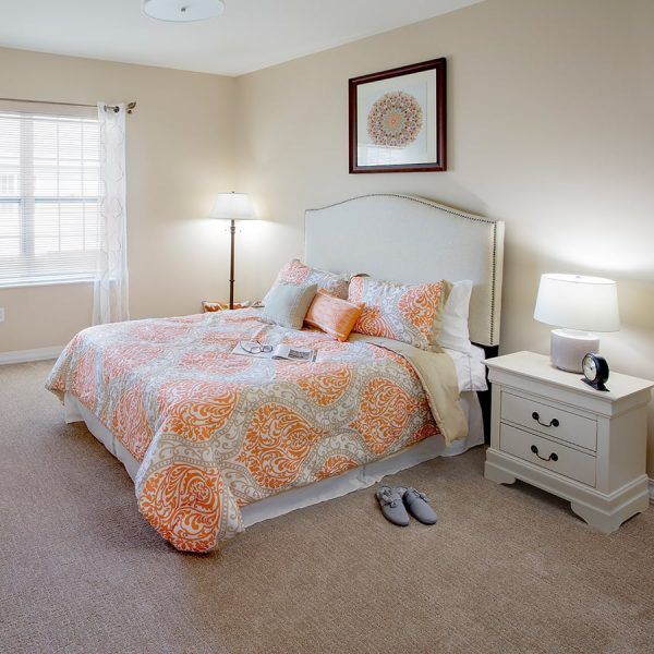 The bedroom of a model apartment at Brooklyn Pointe Assisted Living & Memory Care