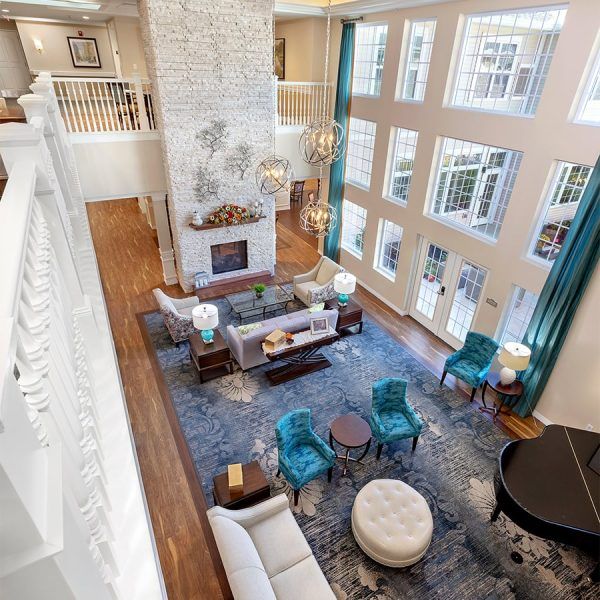 A bird's-eye view of the great room at Brooklyn Pointe Assisted Living & Memory Care, with a fireplace and multiple sitting areas