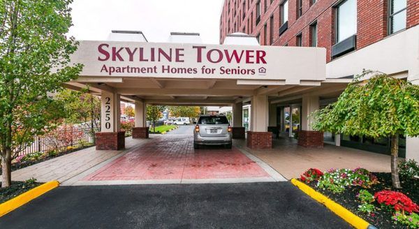The covered pick-up and drop-off area at Skyline Tower Senior Apartments' main entrance
