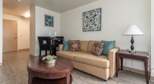 The couch and dining table for two in a model studio apartment at Skyline Tower Senior Apartments