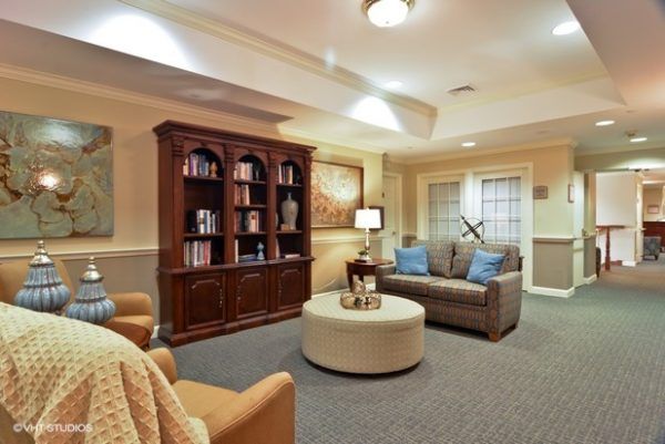 A cozy sitting area next to a bookshelf at The Woodlands of Shaker Heights