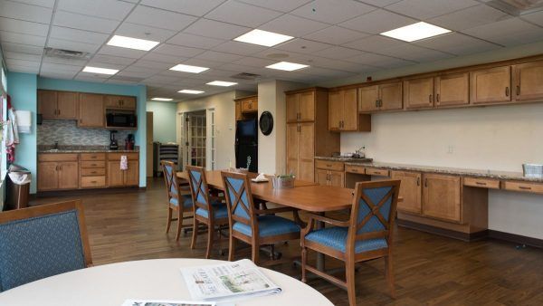 A long table in Kingston Care Center of Sylvania's community kitchen