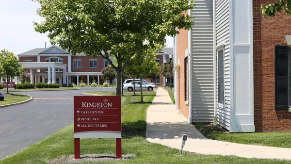 Kingston Care Center of Sylvania's community directional sign and building exterior in the background