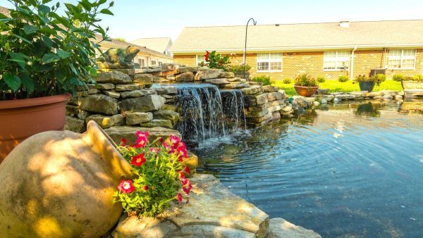 A decorative pond with a waterfall feature at Kingston of Miamisburg