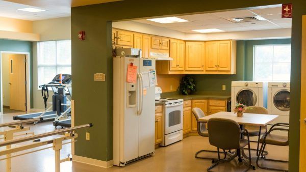 A kitchen and laundry set-up in Kingston of Miamisburg's occupational therapy room
