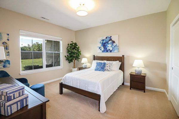 The bedroom of a model villa home at Traditions at North Willow