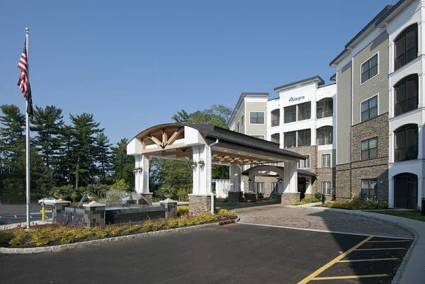 Allegro Harrington Park's 4-story building front and covered main entrance