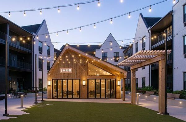 The exterior of Thrive at Montvale's The Hub at night, and string lights across the courtyard