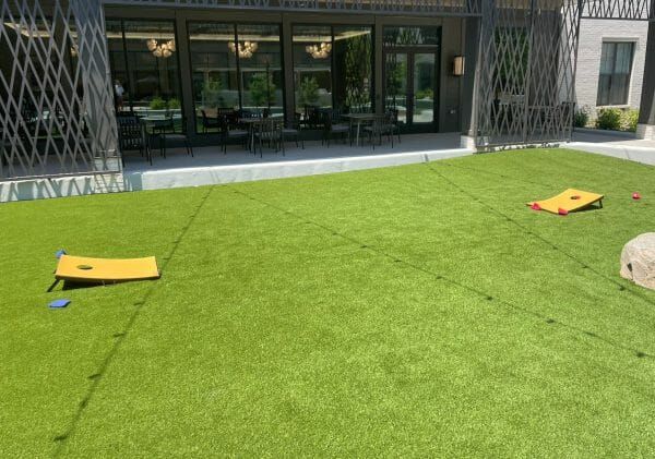 A cornhole game set up on the green at Thrive at Montvale