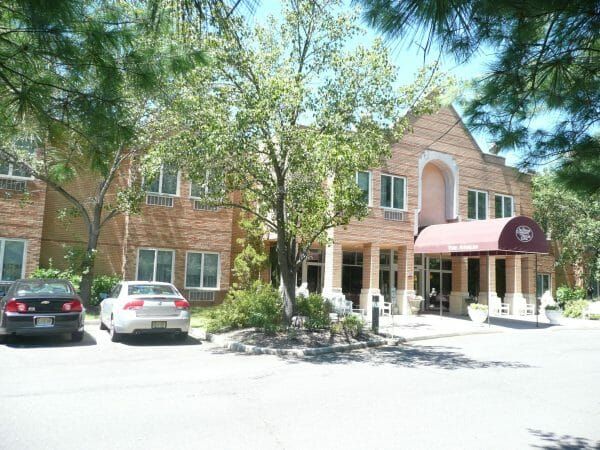 Allendale Enhanced Senior Living's two-story brick front and awning-covered entrance
