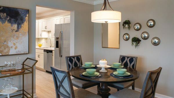 The kitchen and dining area of a model apartment at Cedar Crest Senior Living