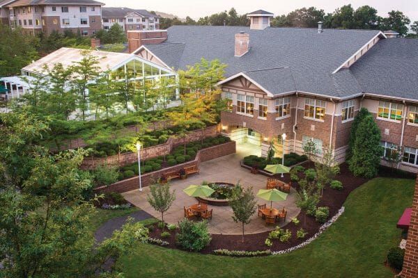 An aerial view of one of the patios at Cedar Crest Senior Living and part of the back exterior of one of the buildings