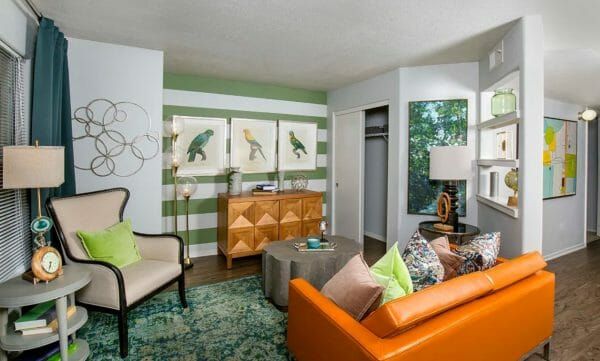 Court Senior Apartments' model apartment living room, decorated in an orange and green tropical theme