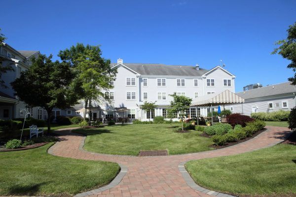 Monmouth Crossing Assisted Living's courtyard and walking path