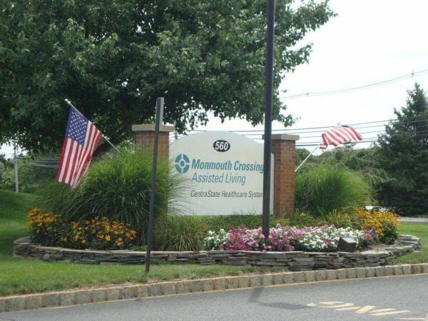 Monmouth Crossing Assisted Living's sign at the entrance to the community