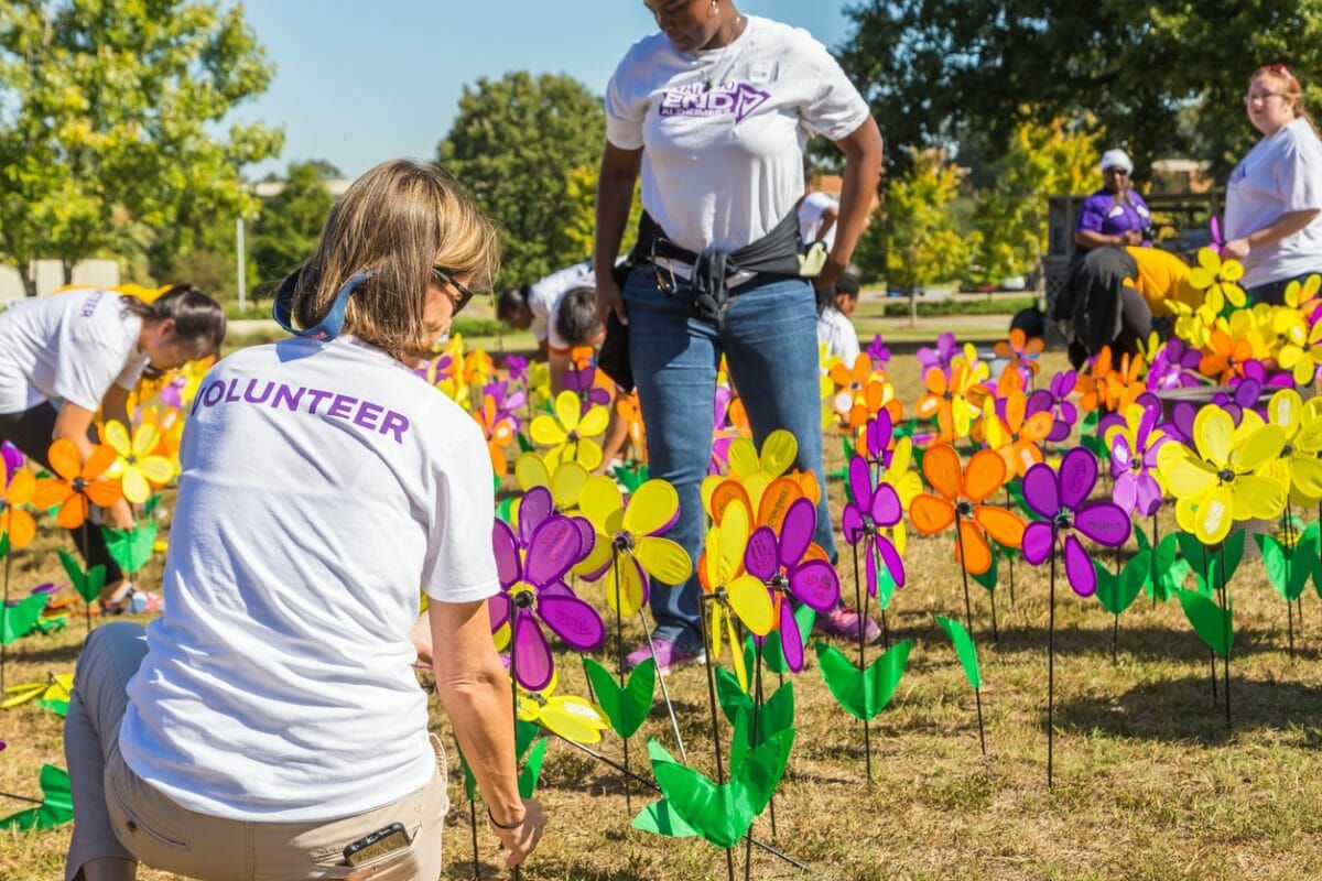 Walk to End Alzheimer's gardens with colorful pinwheel flowers and volunteers