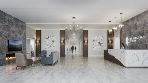 Hamilton Parc lobby with fireplace and seating, marble floors, chandelier and long hallway into the community