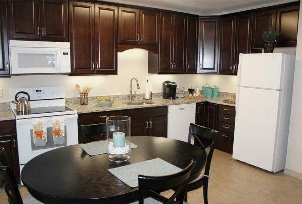 Heritage Run at Stadium Place model home kitchen with eat in kitchen and small refrigerator dishwasher and plenty of cabinet space